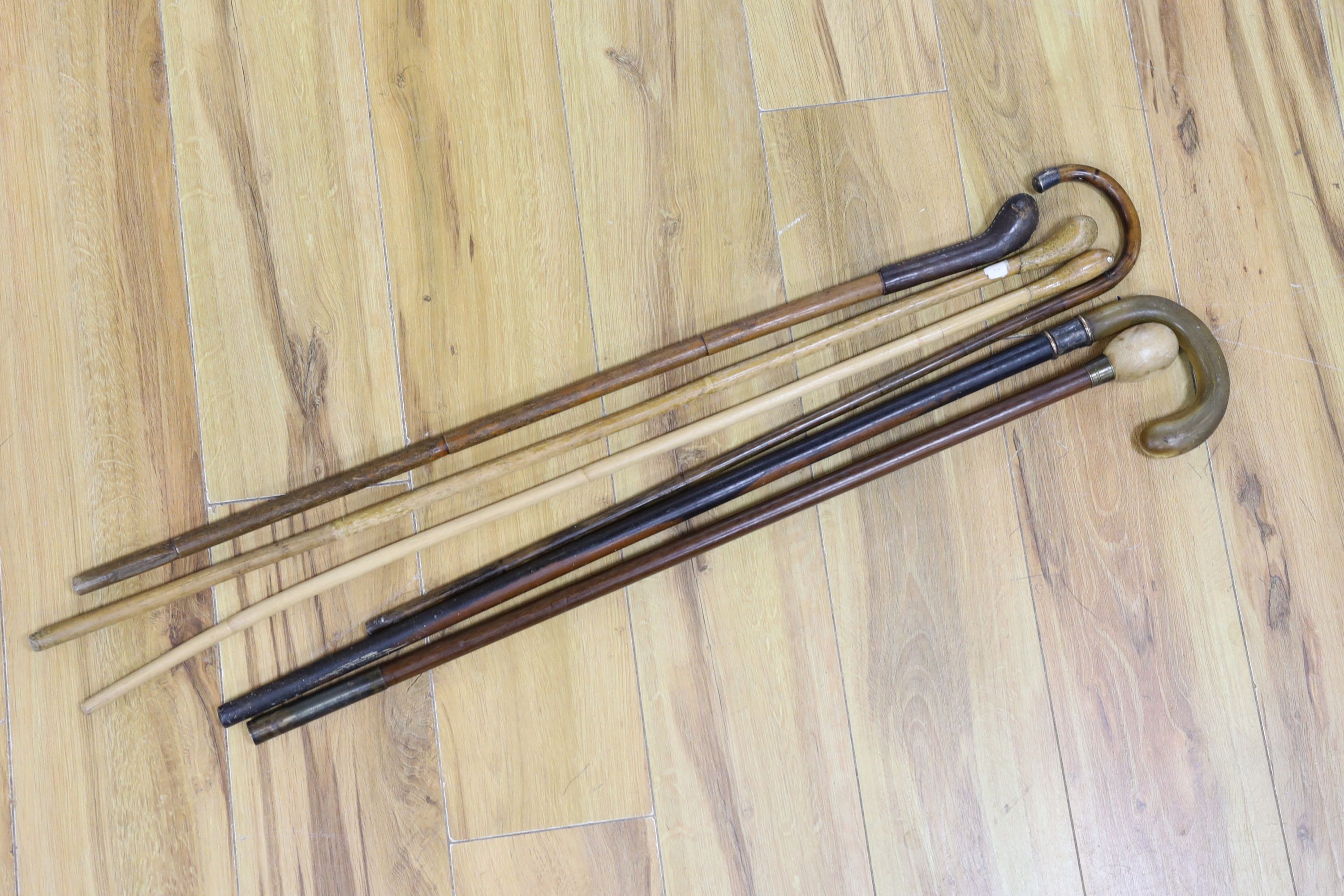Six various walking canes, horn handled cane, 84 cms high.